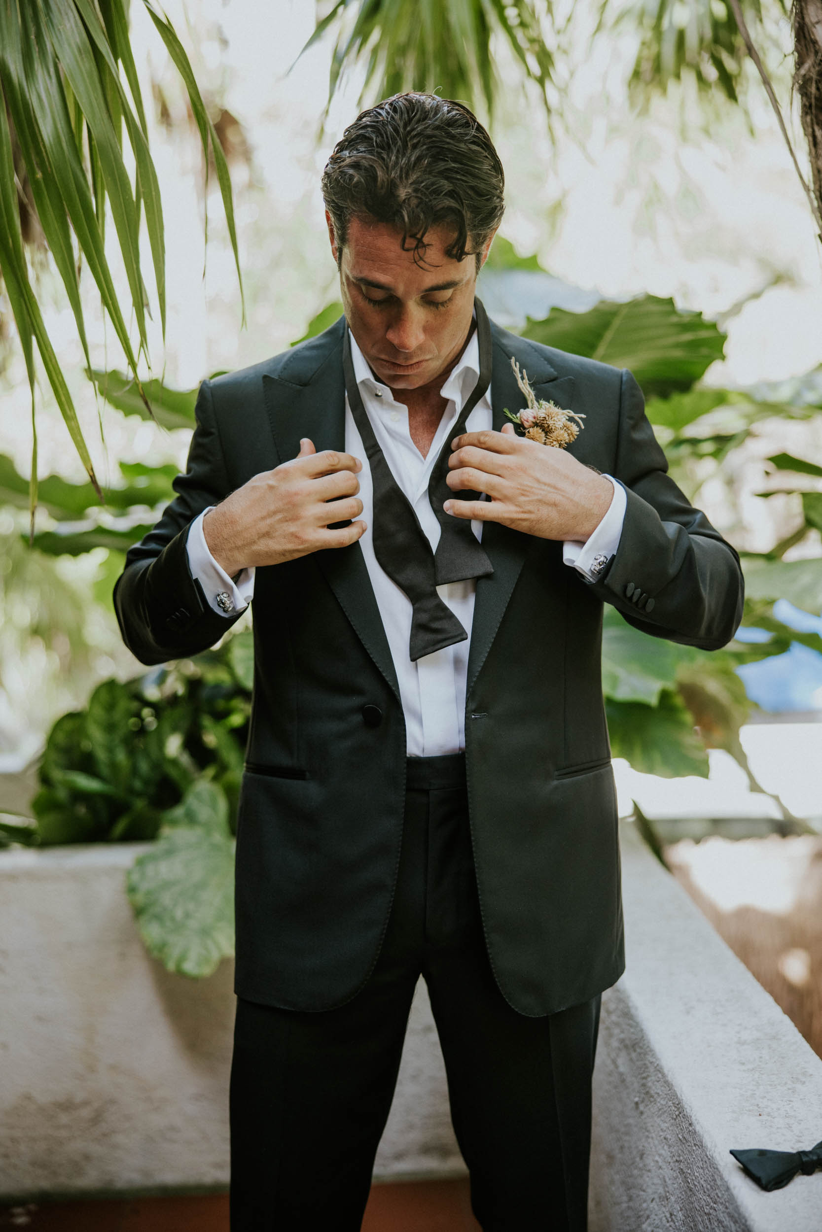 groom getting ready for his elopement in tulum mexico