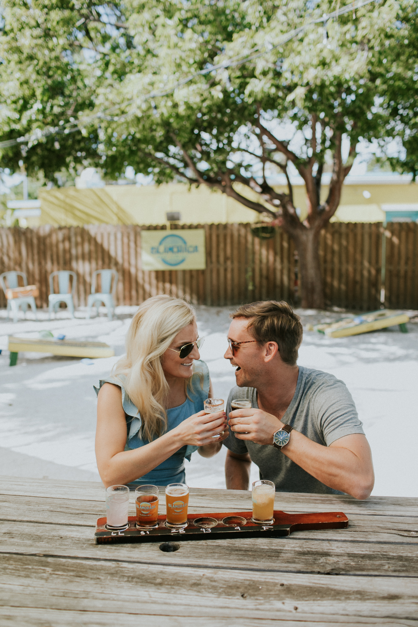 A couple enjoying a few beers during their engagement session