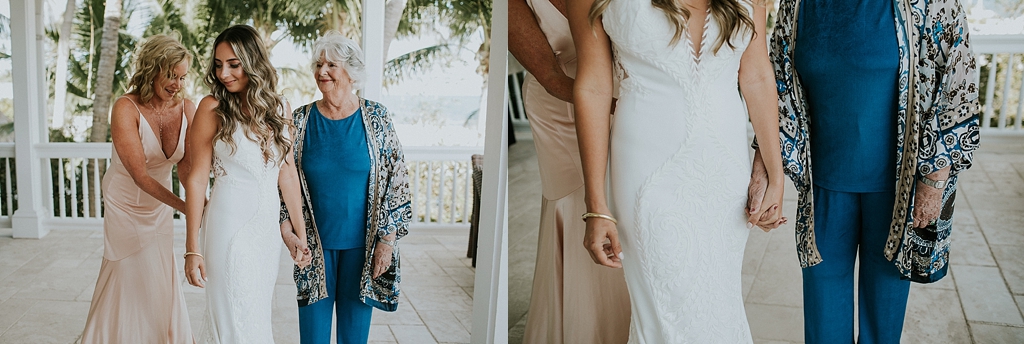 brides mother and grandmother help her with her dress