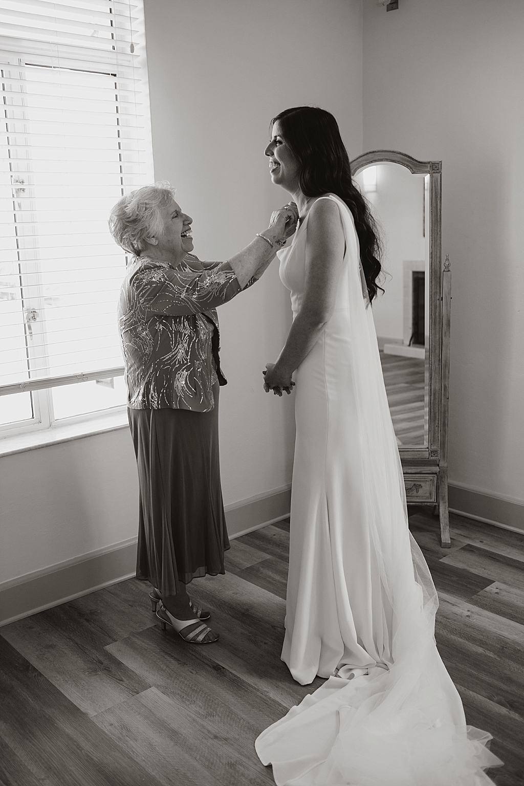 grandma helping bride with jewelry
